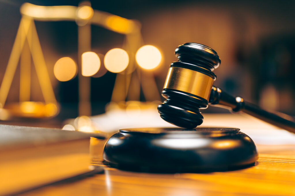 Close up of gavel on desk of corporate law lawyer. 